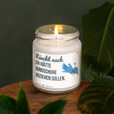 a lit candle sitting on top of a wooden table