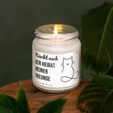 a white candle sitting on top of a wooden table