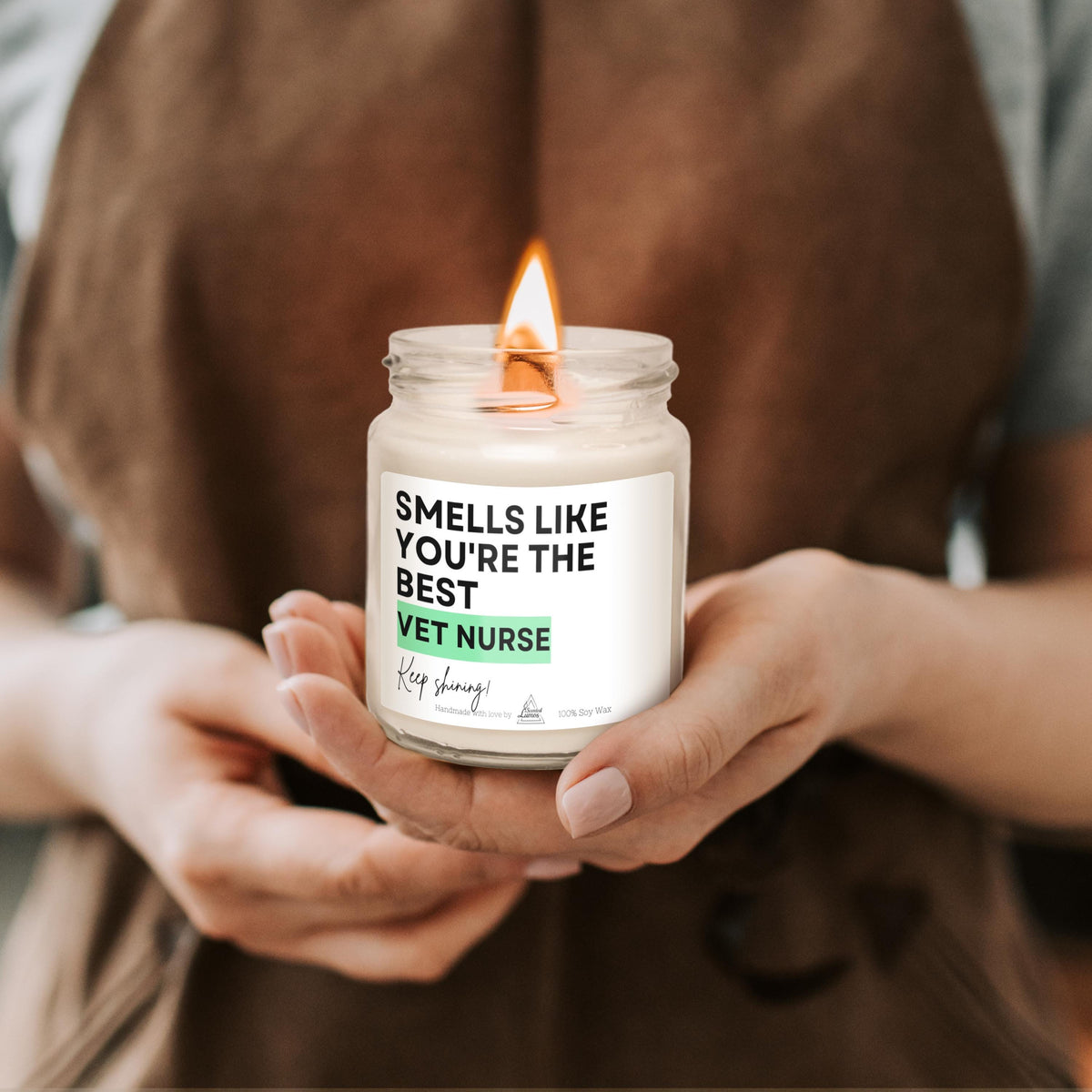 a person holding a jar with a candle in it