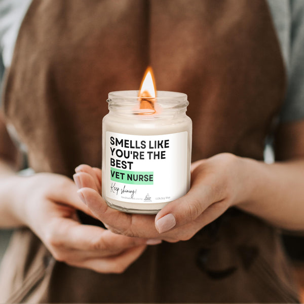 a person holding a jar with a candle in it