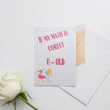 a rose and a piece of paper on a table