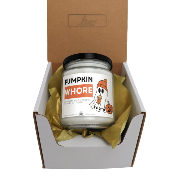 a candle in a box with a yellow ribbon around it