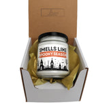a candle in a box that says smells like spooky season