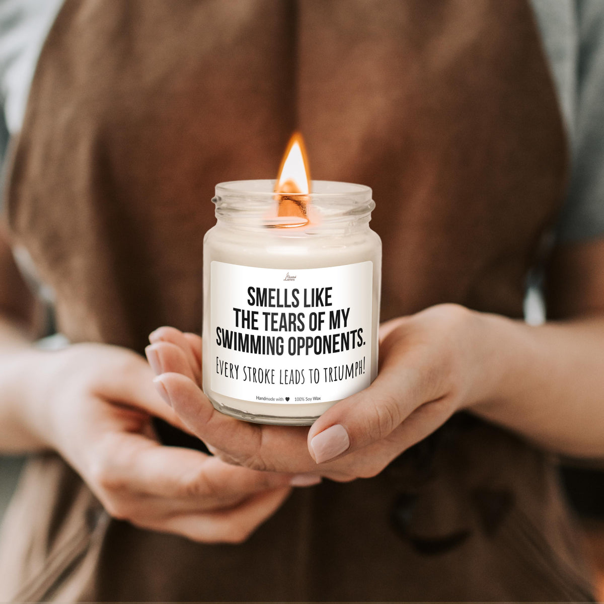a woman holding a candle with a quote on it