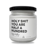 a white jar with a black lid that says holy shit you are half a hundred