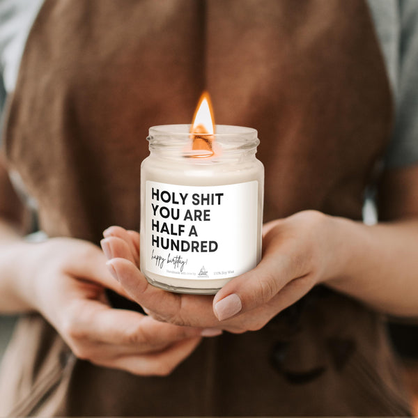 a person holding a candle with a message on it