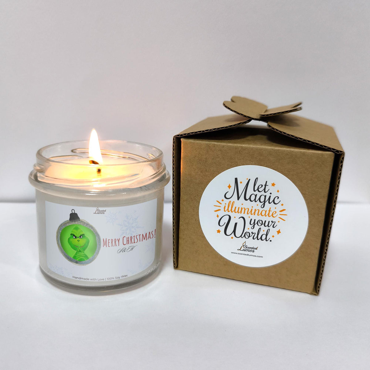 a white candle sitting next to a brown box