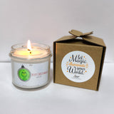 a white candle sitting next to a brown box