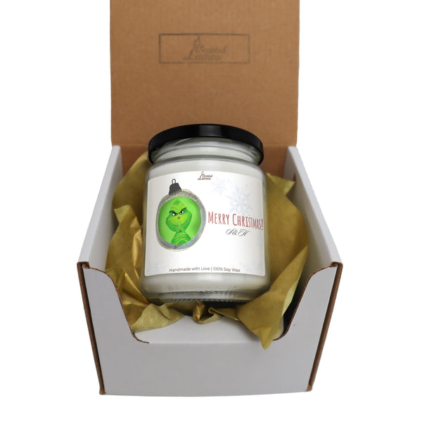 a candle in a gift box with a ribbon around it