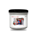 a christmas candle with a picture of two people on it