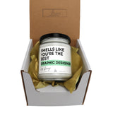 a jar of candles sitting inside of a box