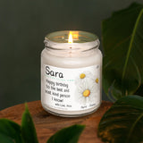 a white candle sitting on top of a wooden table