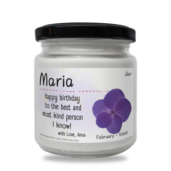 a jar of birthday candles with a purple flower