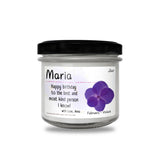 a jar of birthday candles with a purple flower