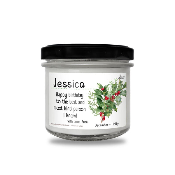 a jar of candles with holly and berries on it