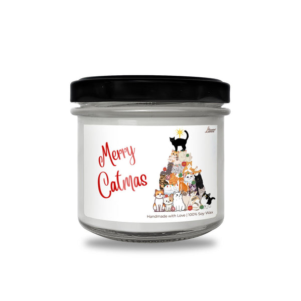 a jar of merry catmas candle with a black lid