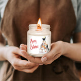 a person holding a candle with a dog on it