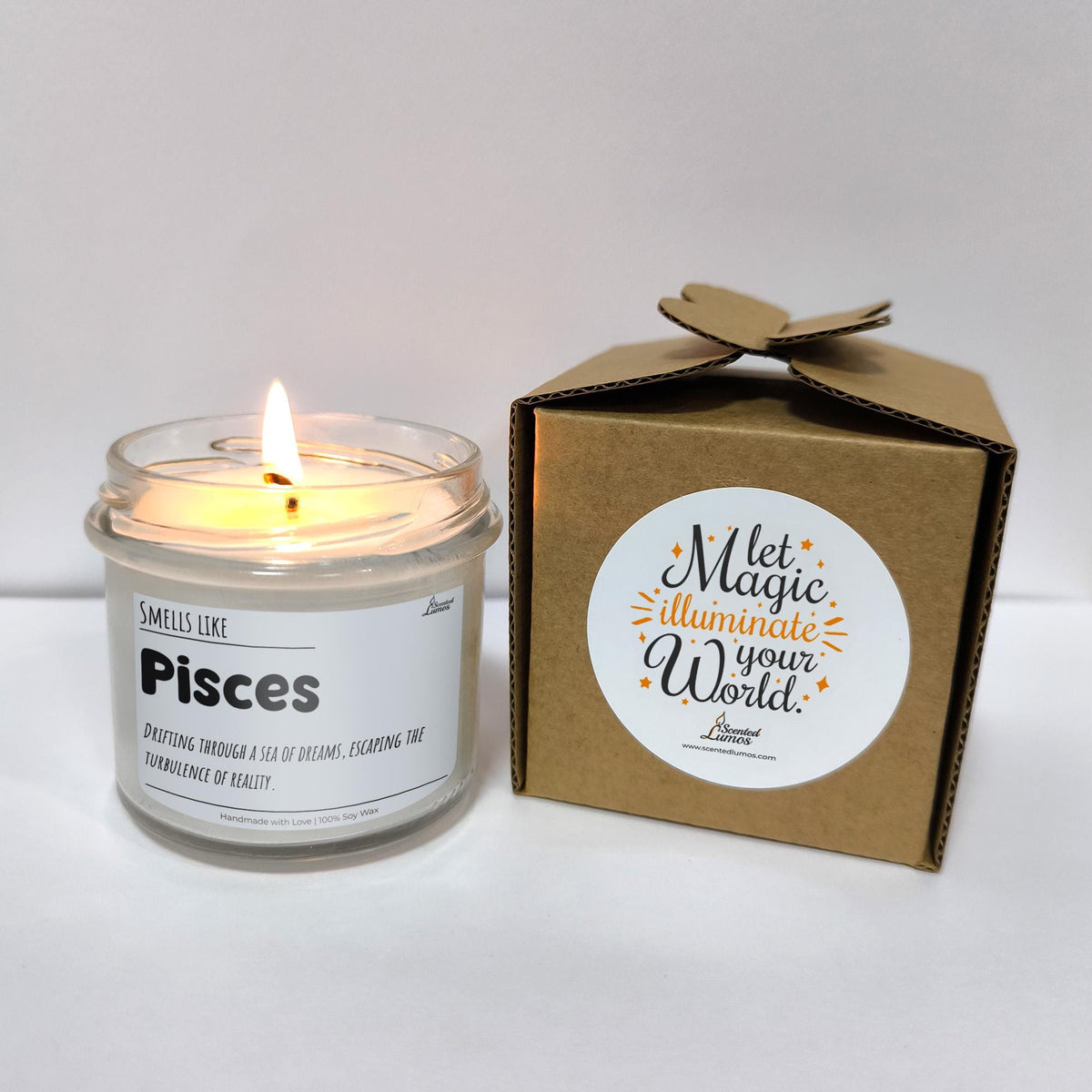 a white candle sitting next to a brown box