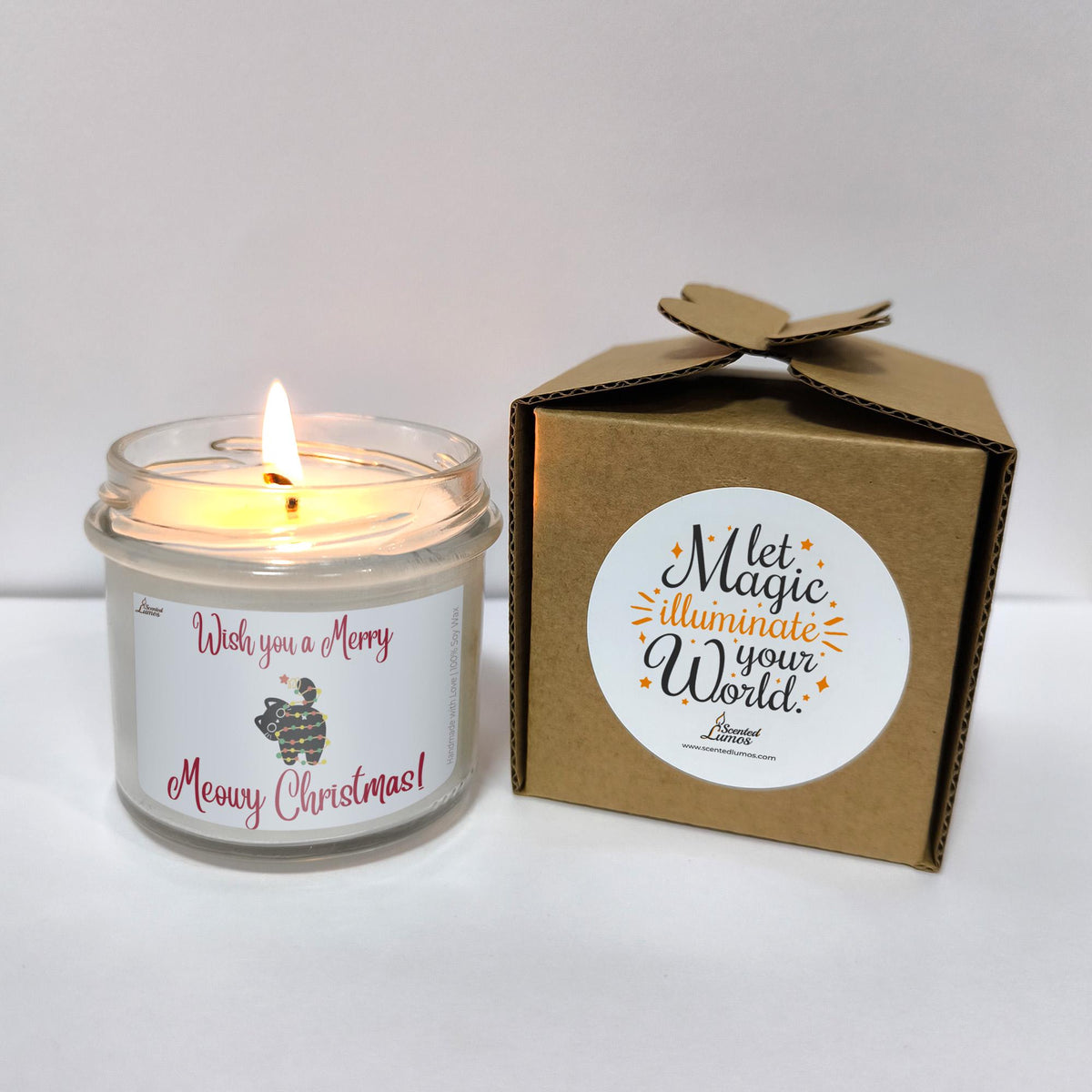 a white candle sitting next to a brown box