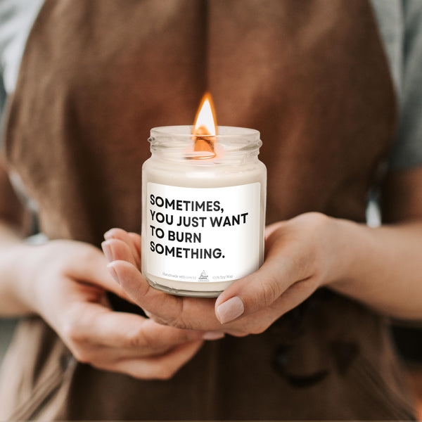 a person holding a candle with a message on it