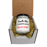 a small jar of roller derby sits in a box